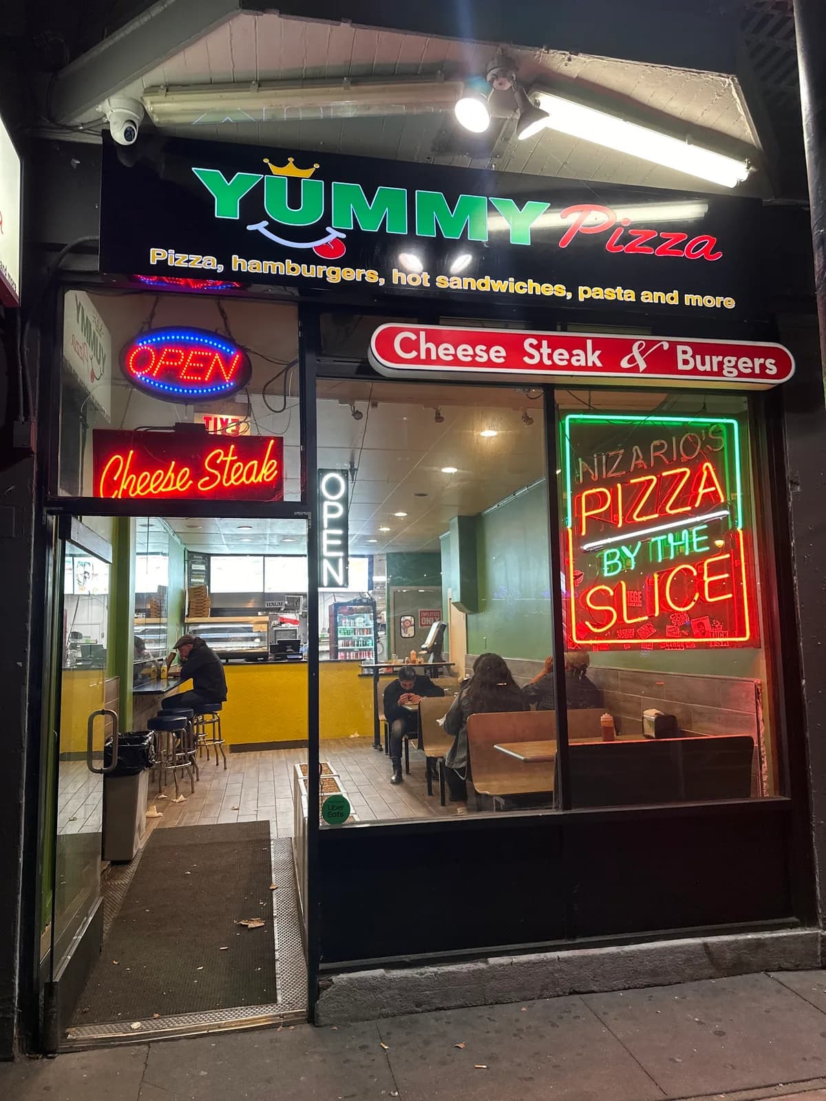 Yummy Pizza storefront on Valencia Street at night in San Francisco
